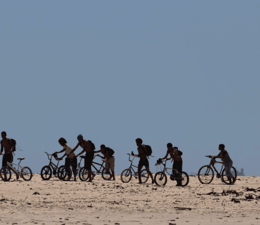 What’s the net worth of your cycling group? Group of people cycling and pushing their bike off road