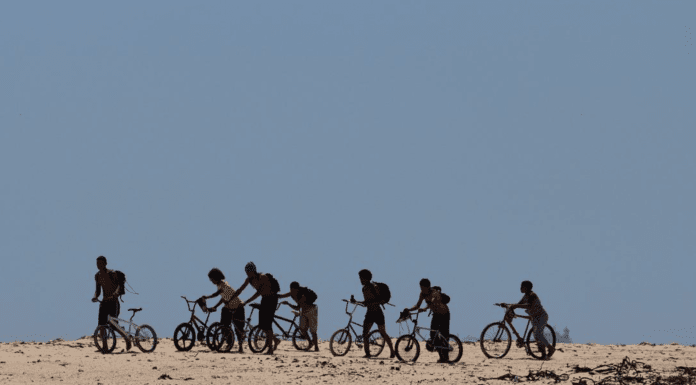 What’s the net worth of your cycling group? Group of people cycling and pushing their bike off road