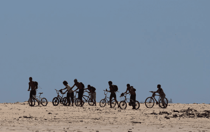 Group of people cycling and pushing their bike off road