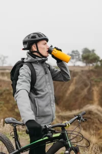 Winter cycling tips: Drink water during cycling to stay hydrated. 